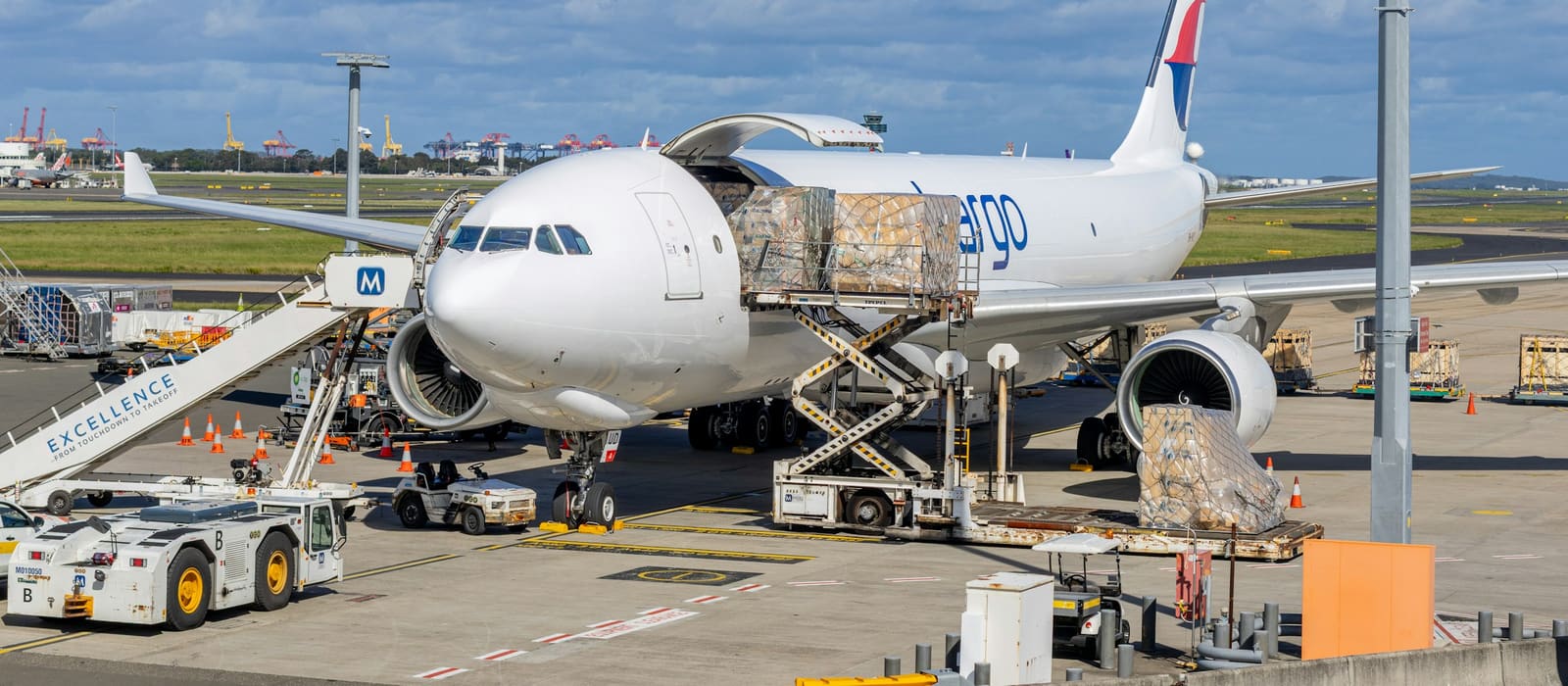 Freight being loaded into a cargo aircraft on the airport tarmac