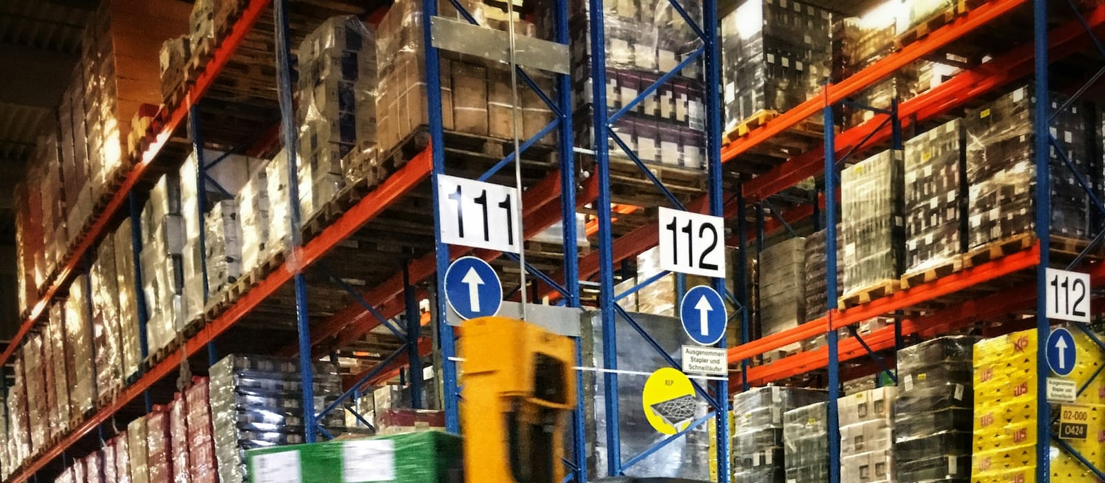 Goods on warehouse racking being checked and inventoried