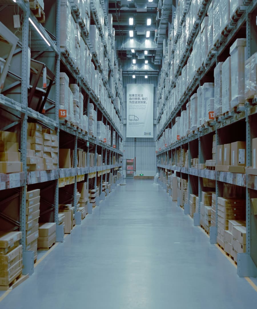 Warehouse aisle stacked with palletised cargo ready for despatch